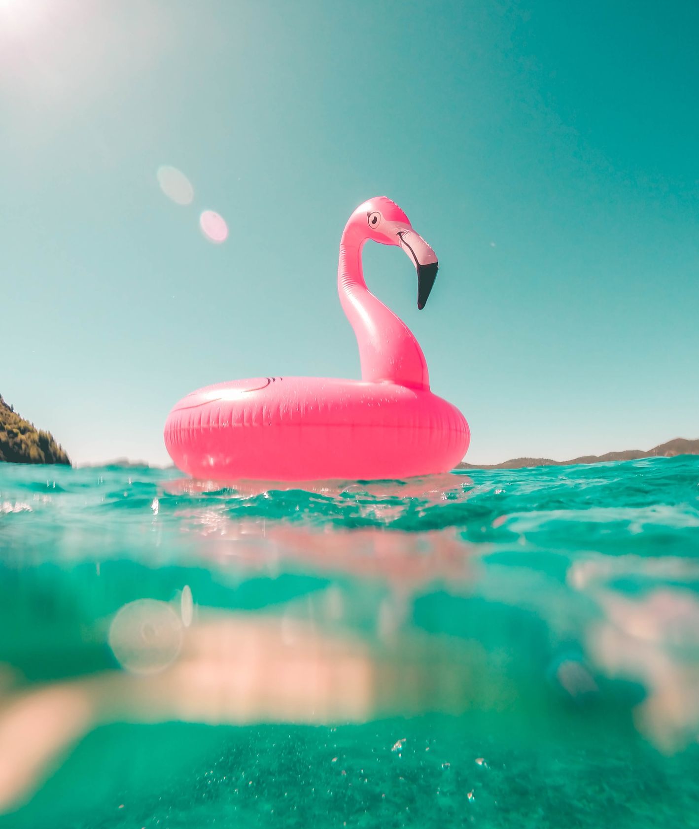 Koło do pływania w kształcie flaminga pływające na morzu (fot. Vicko-Mozara / unsplash)