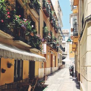 Hiszpańska, wąska uliczka z kwiatami (fot. Jonas Hoss / unsplash.com)
